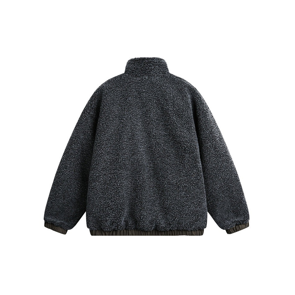 Back view of a charcoal textured jacket with a stand collar and gathered cuffs and hem.