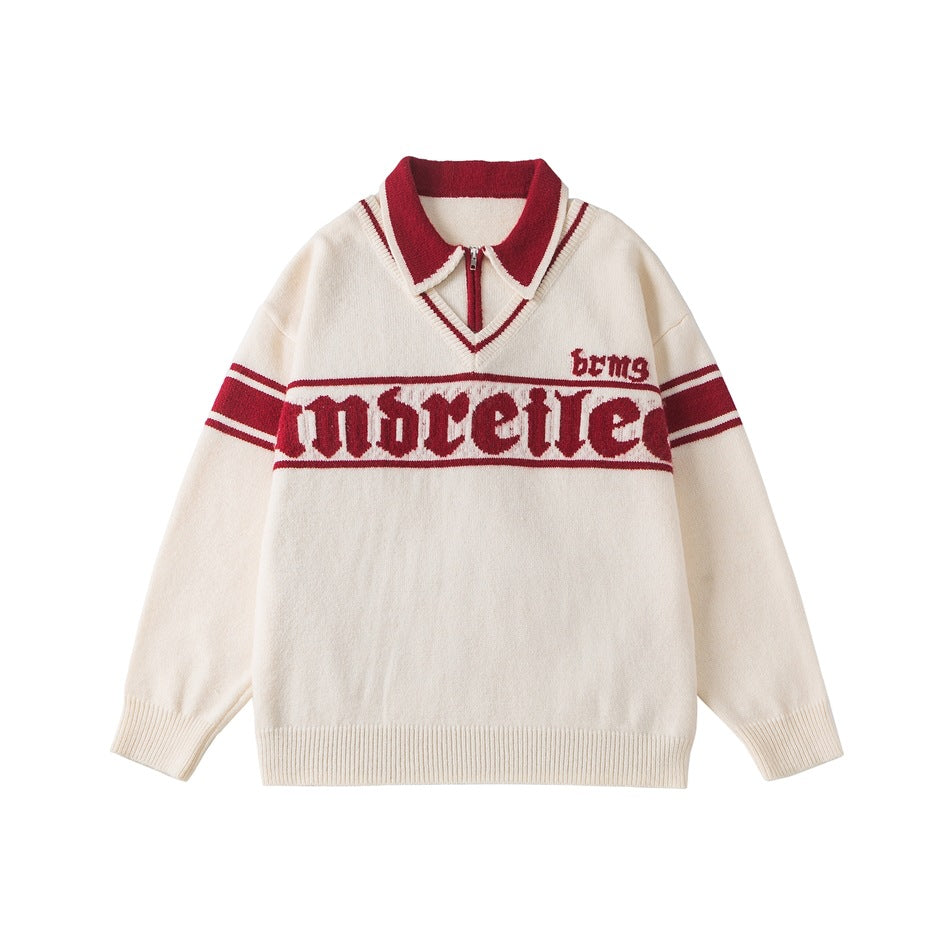 Beige knit pullover with red double collar, half zipper, gothic lettering band and red striped sleeves, flat lay