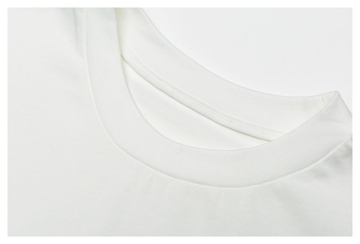 Close-up of the white garment's round ribbed neckline and stitching.