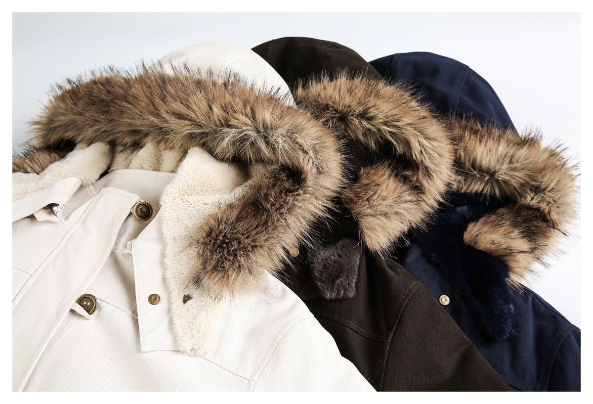 Close-up of ivory, dark brown and navy hooded jackets with brown faux-fur trim.