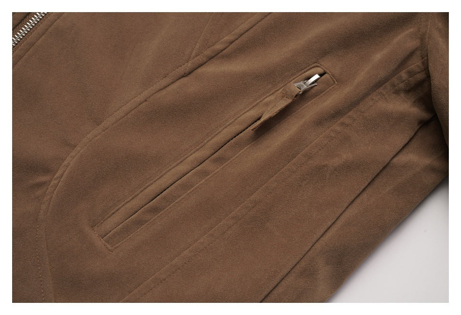 Close-up of a slanted zippered pocket on a brown jacket.