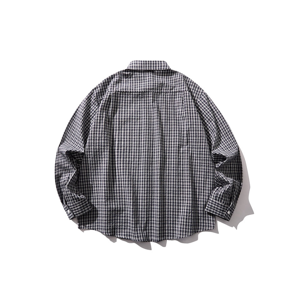 Back view of blue and white small-check long-sleeve shirt laid flat, showing back yoke and buttoned cuffs