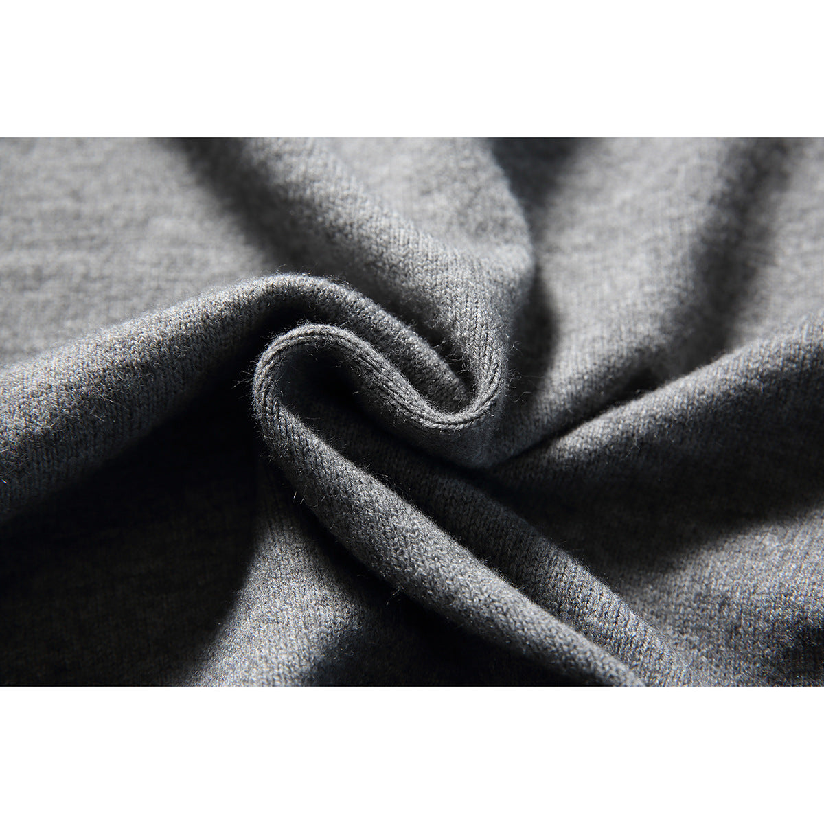Close-up of softly folded gray knit fabric showing its texture.