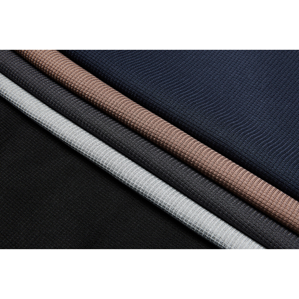 Textured knit fabric shown in overlapping black, charcoal, light gray, tan, and navy colorways.