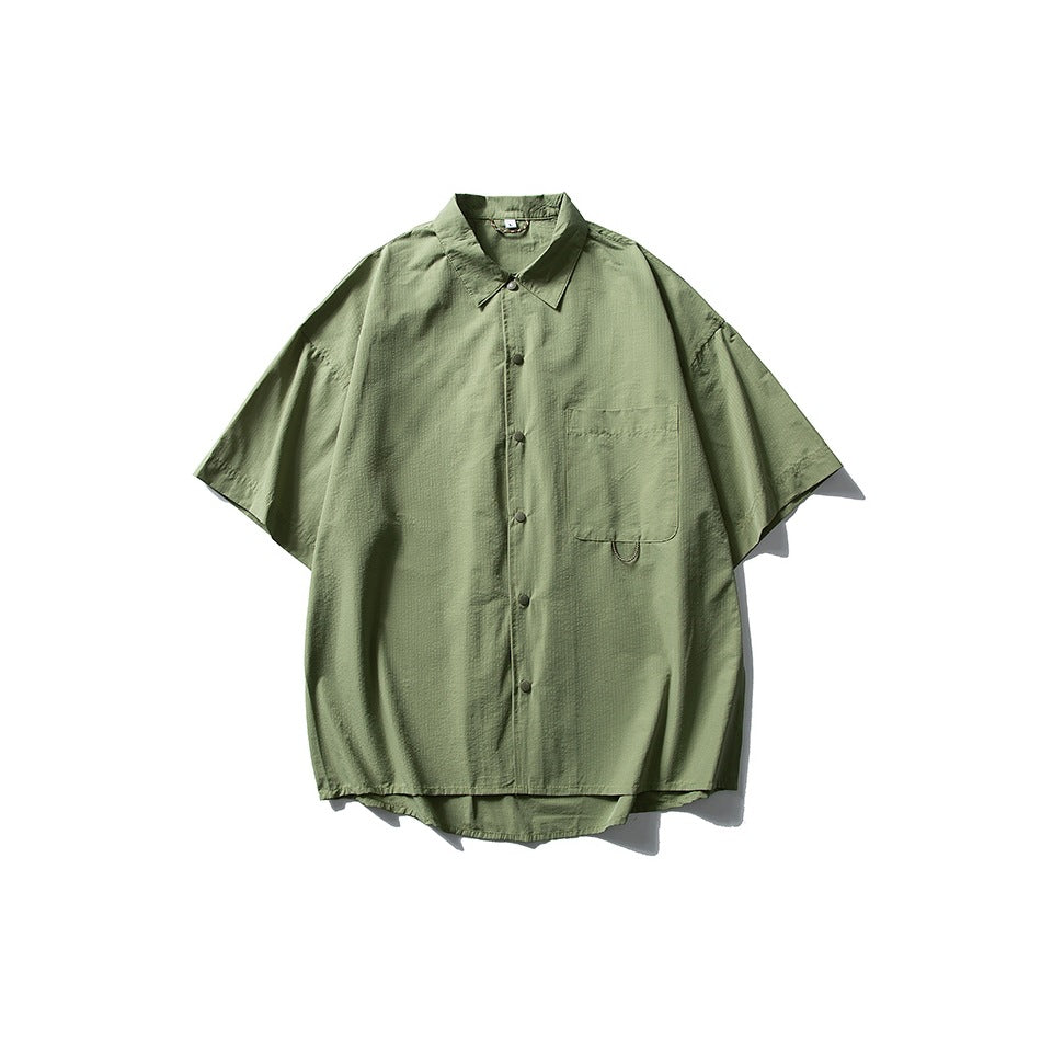 Green short-sleeve button-front shirt with collar and chest pocket, flat lay on white background