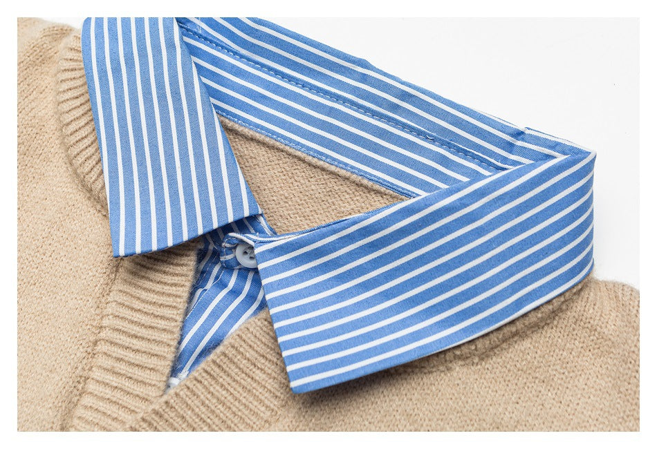 Close-up of a blue-and-white striped shirt collar layered over a beige knit sweater.