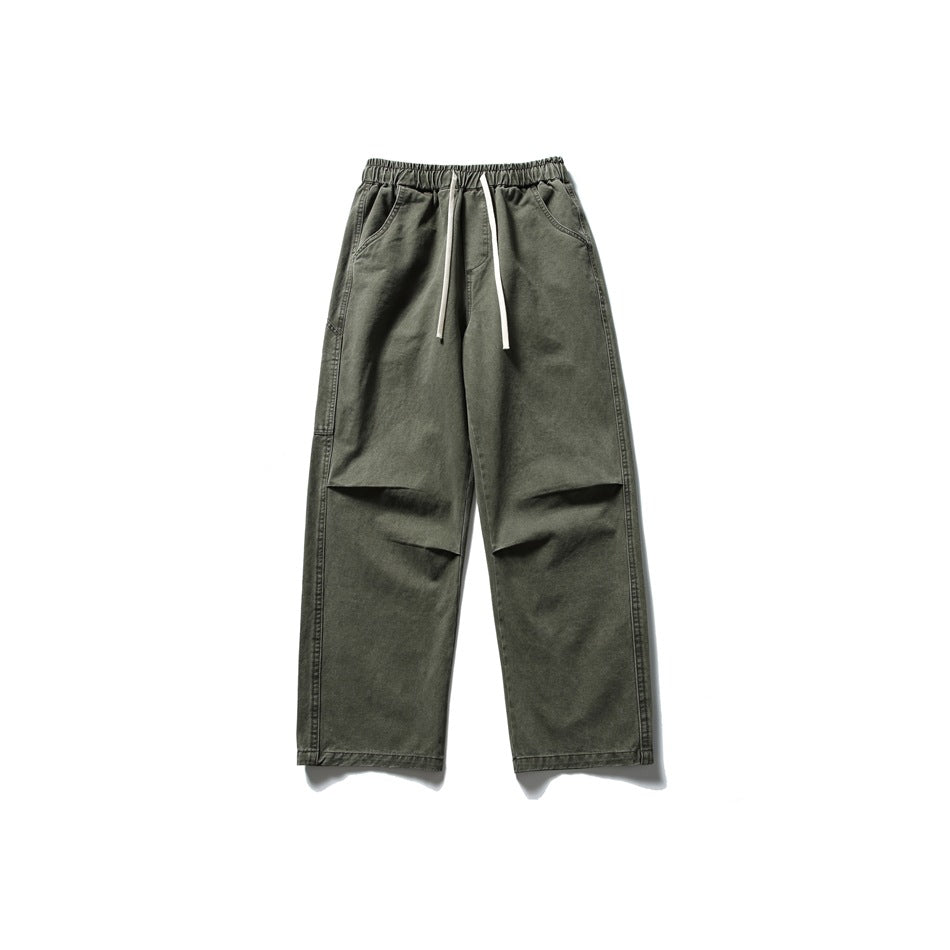 Army green straight-leg pants with elastic drawstring waist, front pockets and pleated knees, flat front view