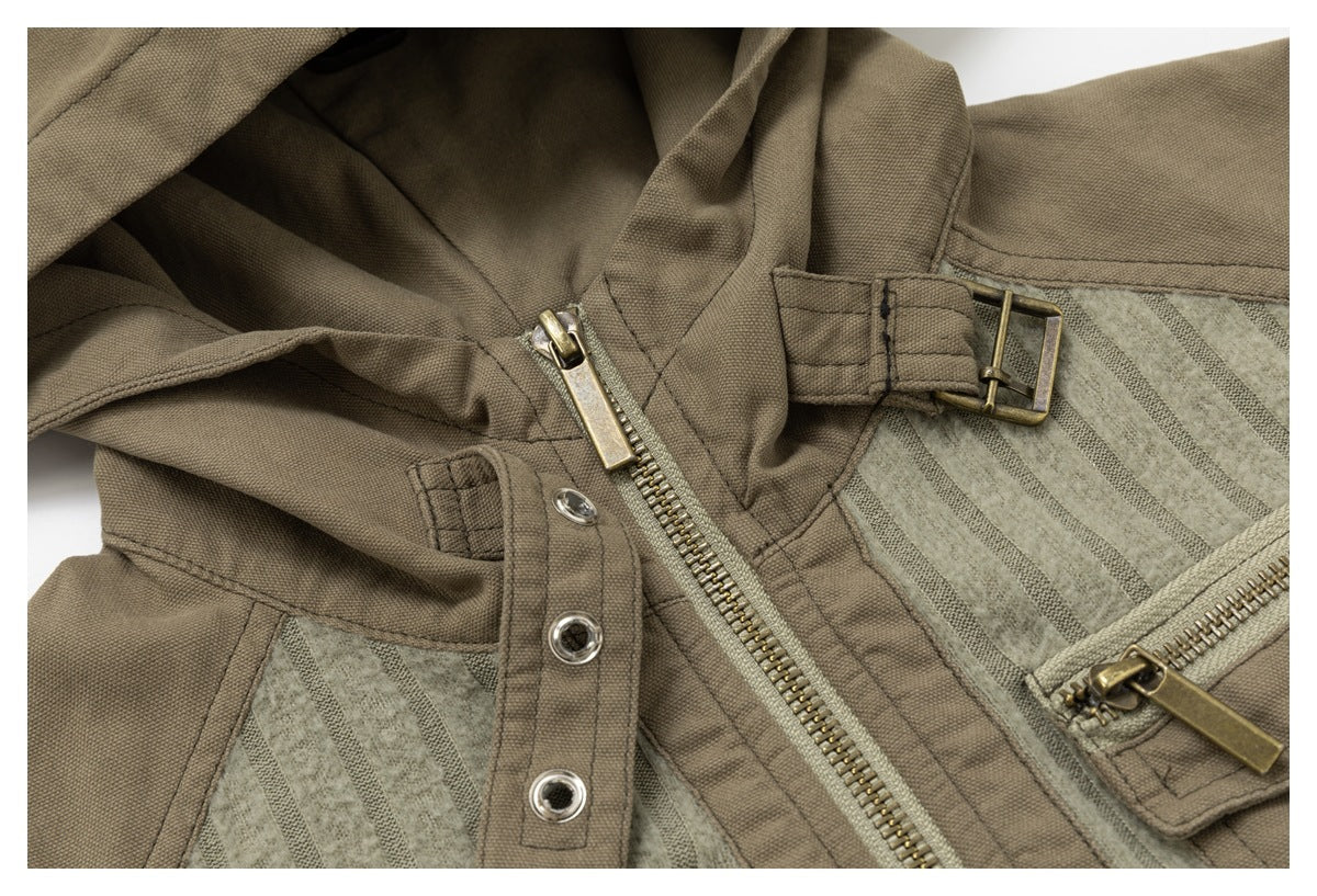 Detail of the jacket's hood fastening, brass-tone zipper and buckle, and ribbed sage fabric with taupe trim.