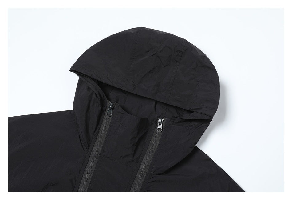 Close-up of a black jacket's hood and upper front with two zipper tracks.