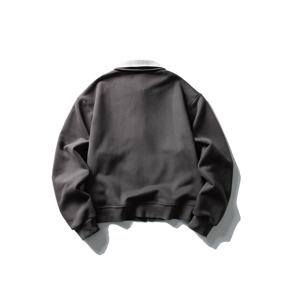 Back view of dark gray zip jacket with light collar, plain back panel, ribbed cuffs and hem, flat lay