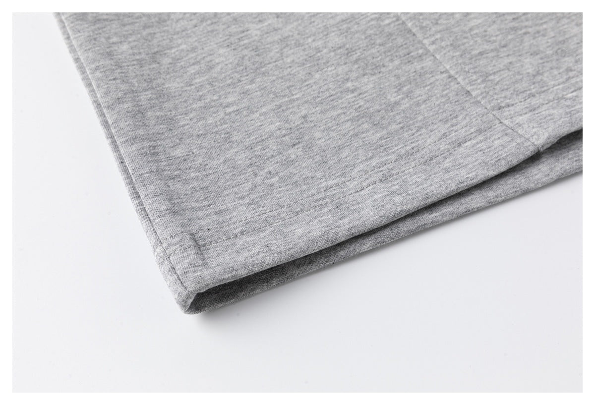 Close-up of the stitched bottom hem on a heather-gray T-shirt.