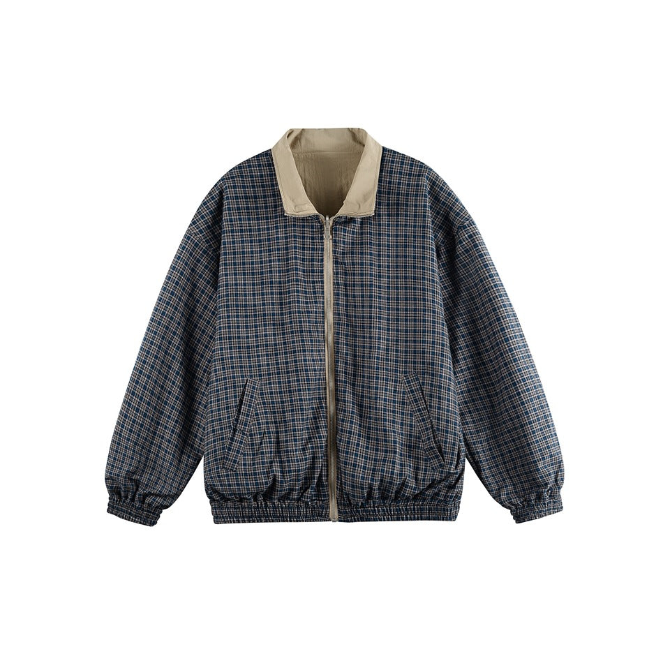 Front view of a navy, gray and tan plaid zip jacket with a beige collar, slanted pockets, elastic cuffs and hem.