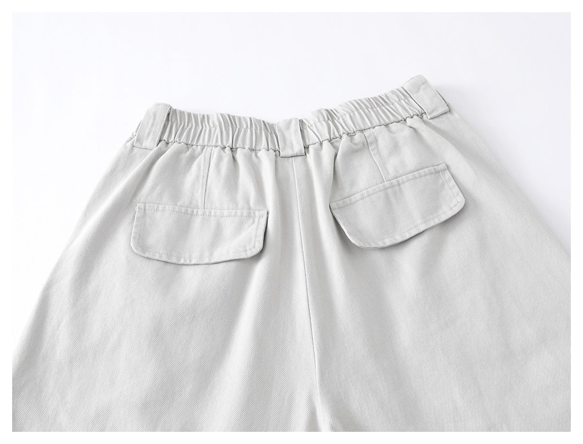 Back view of light gray trousers with an elasticated waistband, belt loops, and two patch pockets.