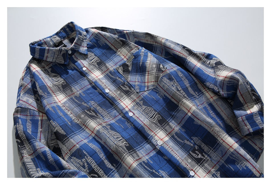 Close view of a blue plaid button-up shirt showing its collar, chest pocket, buttons, and pattern.