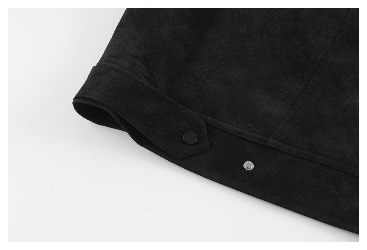 Close-up of a black jacket sleeve cuff with a snap button and visible stitching.