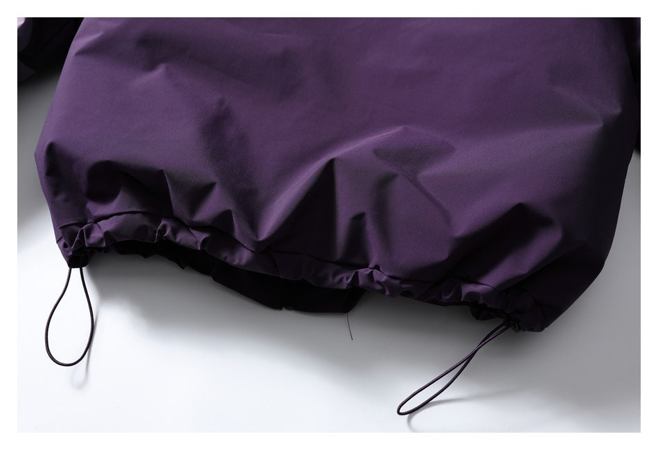 Close-up of the deep purple jacket's gathered hem and adjustable drawcords.