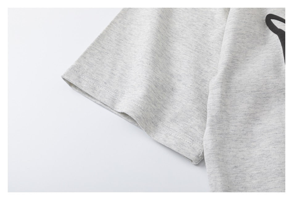 Close-up of the short sleeve and stitched hem on a light gray heather T-shirt.