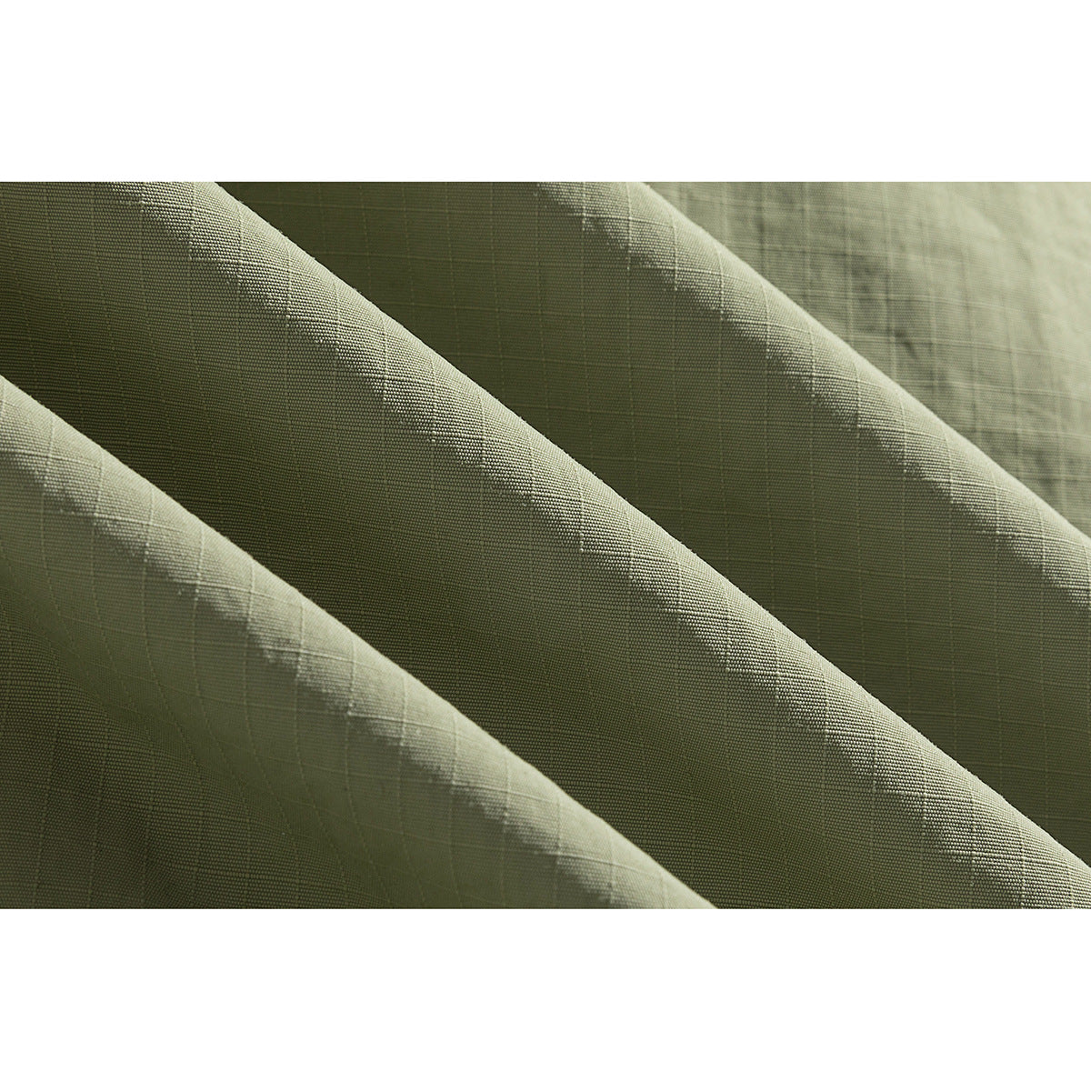 Close-up showing the fine grid texture of olive-green jacket fabric.