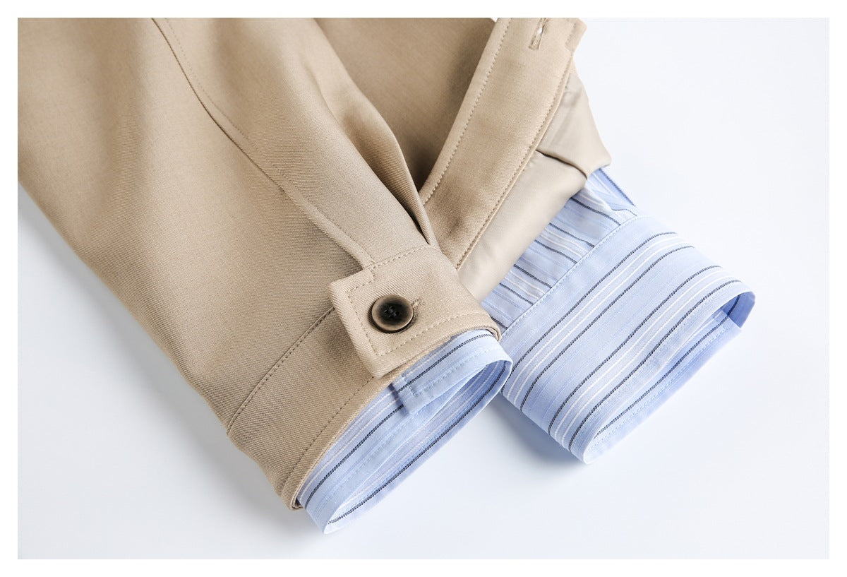 Beige sleeve cuffs with dark buttons reveal light blue fabric patterned with narrow stripes.