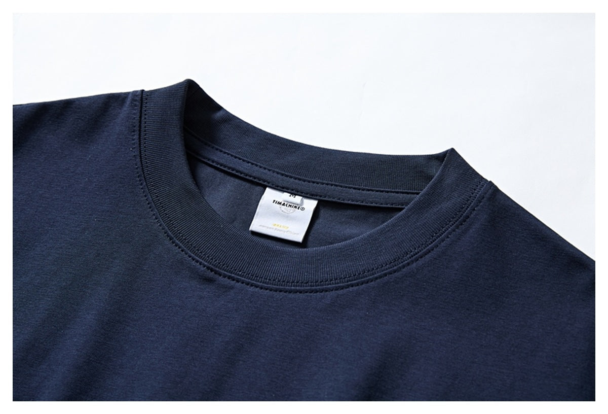 Close-up of a navy T-shirt's ribbed crew neck and inner label.