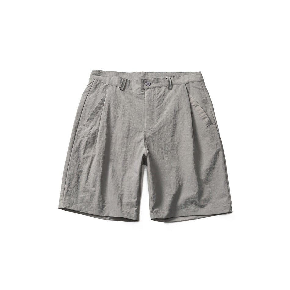 Gray pleated knee-length shorts with a button waistband, belt loops and slanted side pockets, shown flat from the front