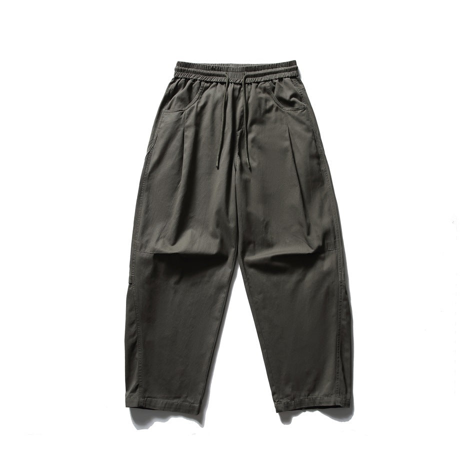 Army green wide-leg pants with elastic drawstring waist and slanted front pockets, flat lay front view