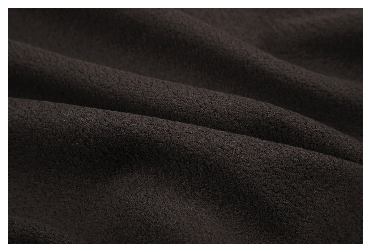 Close-up of dark brown, softly textured fabric arranged in broad folds.
