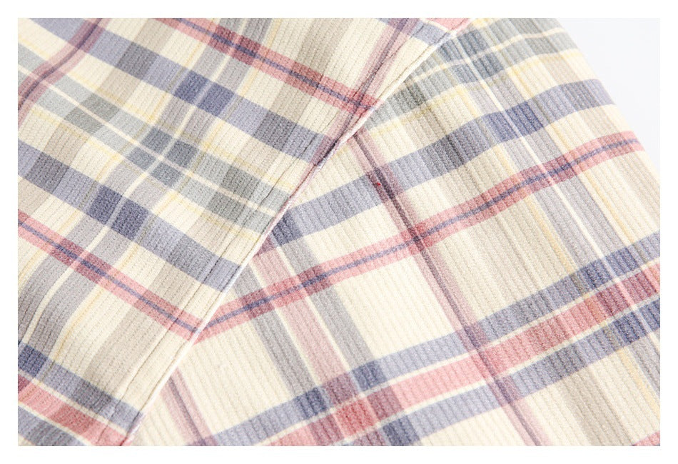 Close-up of the cream, gray, and muted red plaid fabric with a visible stitched seam.