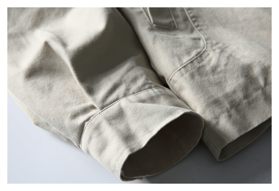 Close-up of the off-white jacket sleeve cuff and adjacent seam, showing the textured fabric.