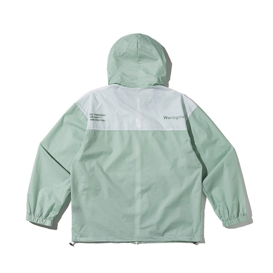 Back view of mint green hooded jacket with white perforated-look upper panel and small printed text