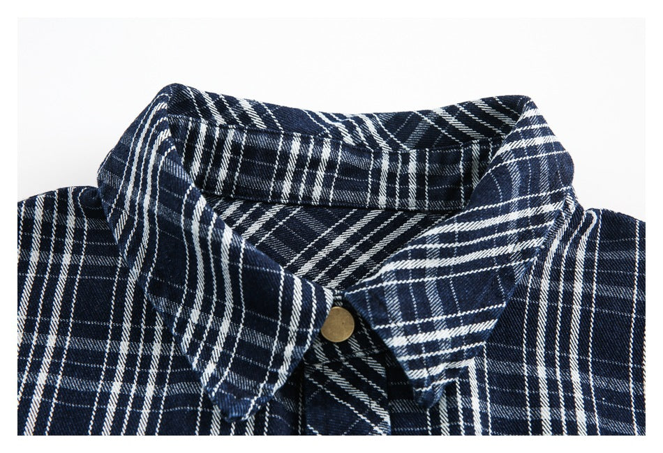 Close-up of the navy plaid shirt collar and a brass-tone snap fastener.