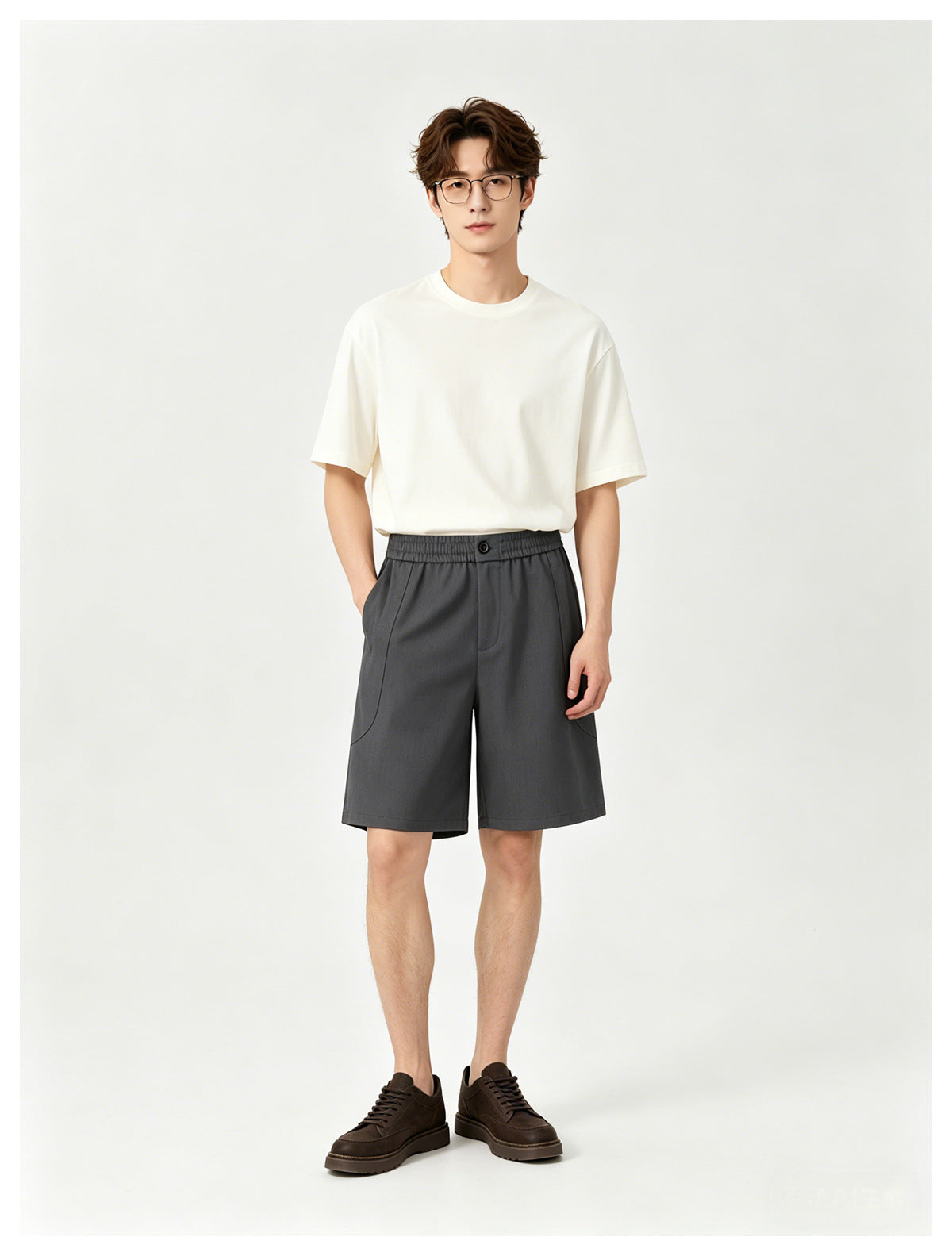 Model wearing a white crew-neck T-shirt and charcoal knee-length shorts, shown from the front.