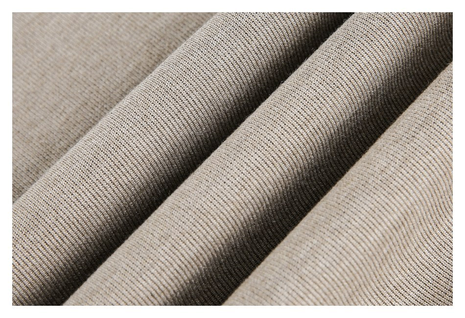 Close-up of beige rib-knit fabric folded to show its texture.