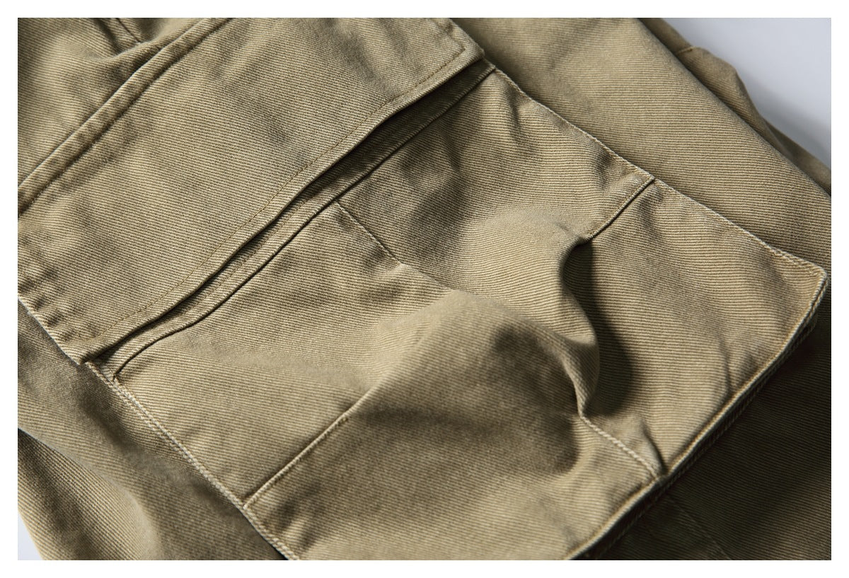 Close-up of khaki trousers showing a large stitched cargo pocket and flap.
