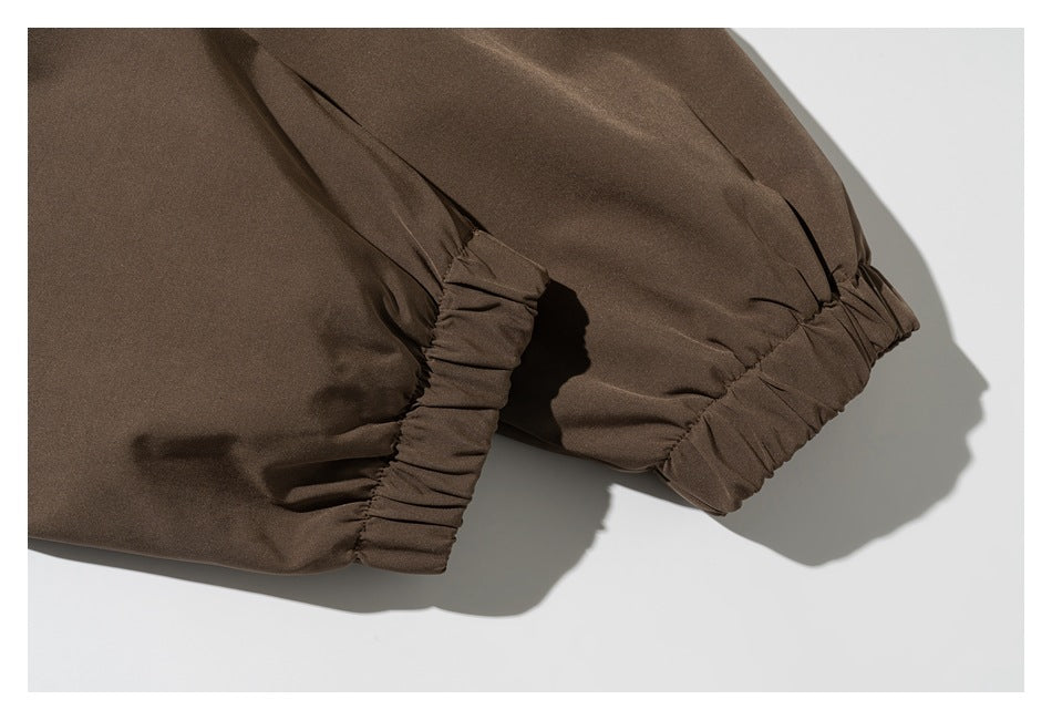 Close-up of brown sleeves with gathered elastic cuffs.