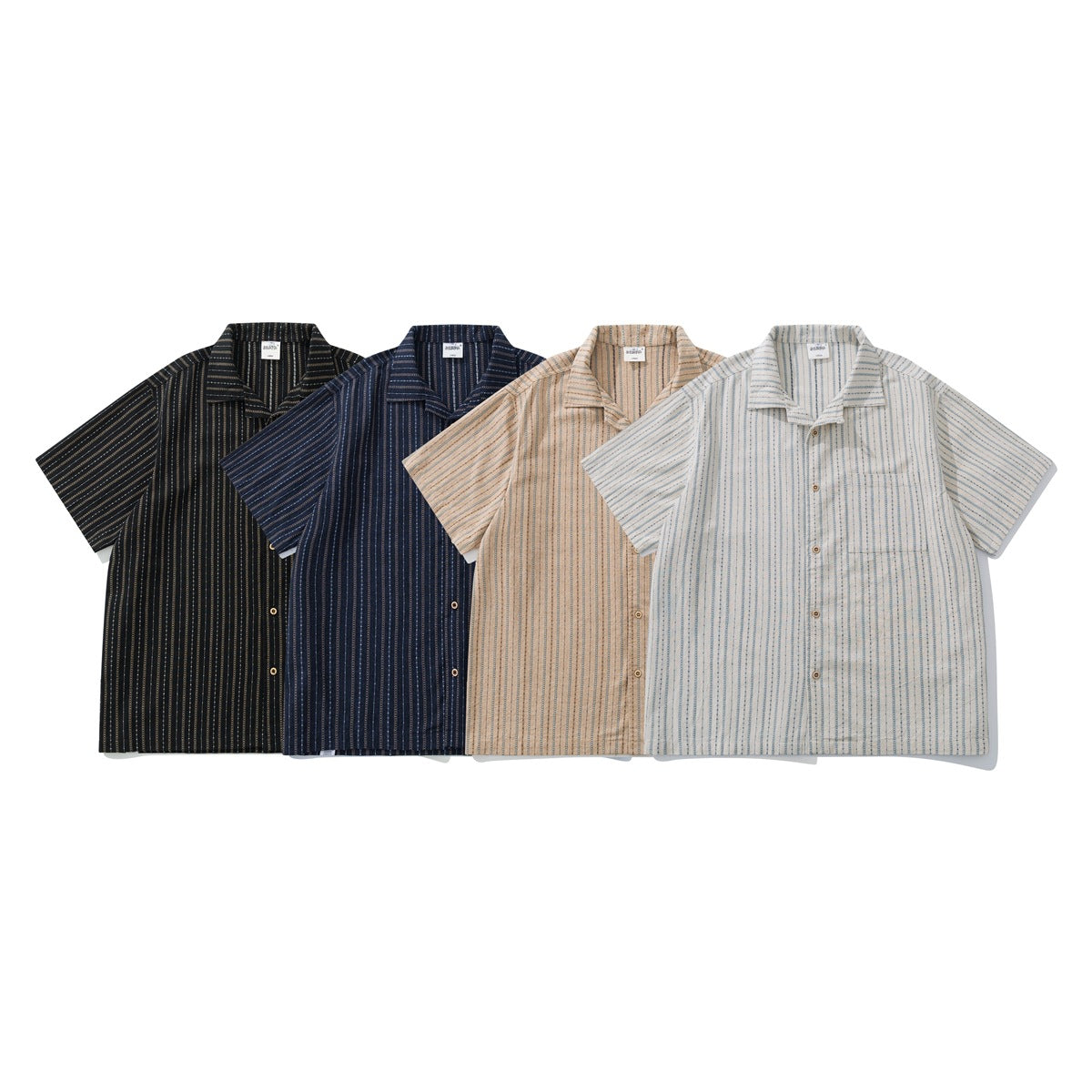 Four short-sleeve button-up shirts with patterned vertical stripes in black, navy, tan and cream with blue.