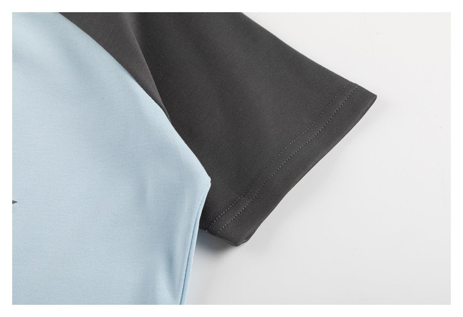 Close-up of a charcoal short sleeve and light blue body, showing the sleeve hem stitching.