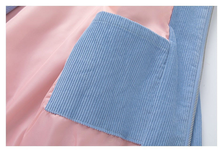 Close-up of a large blue corduroy patch pocket against pink jacket lining.