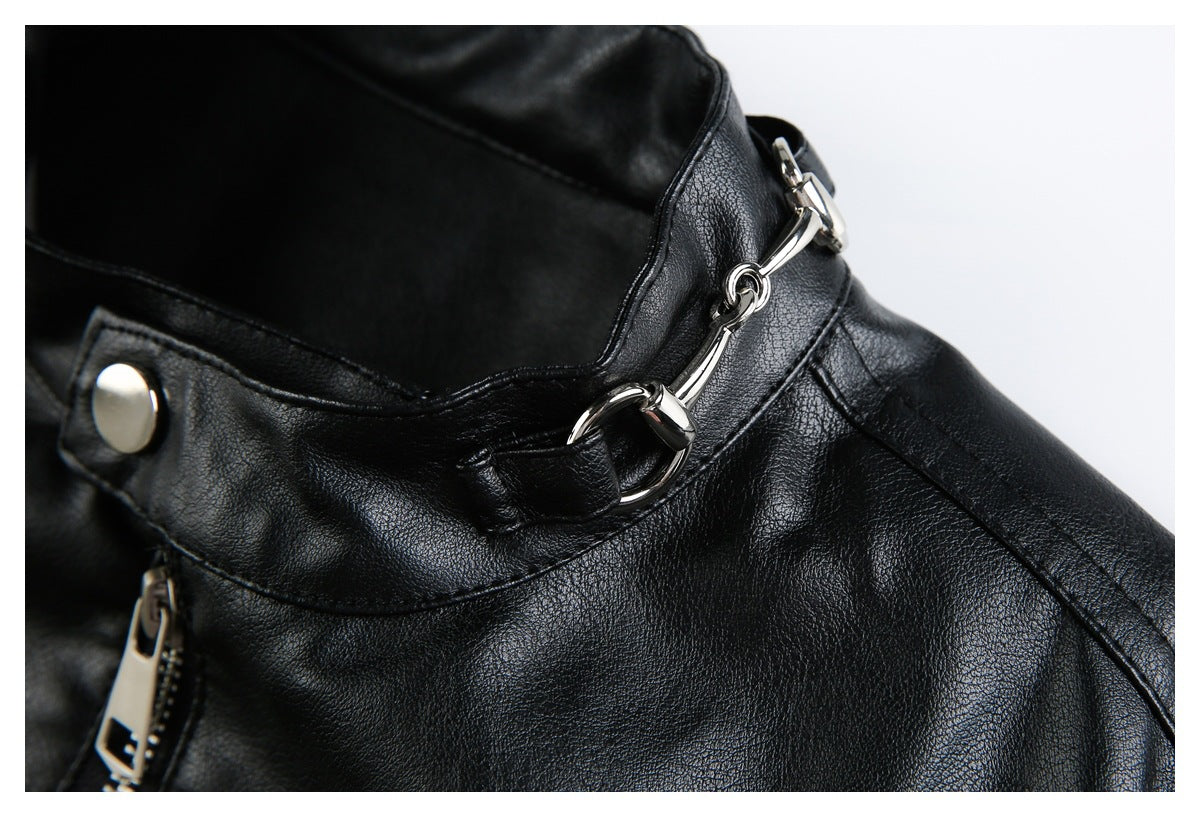 Close-up of a black jacket collar with a silver bit-style clasp and snap button.
