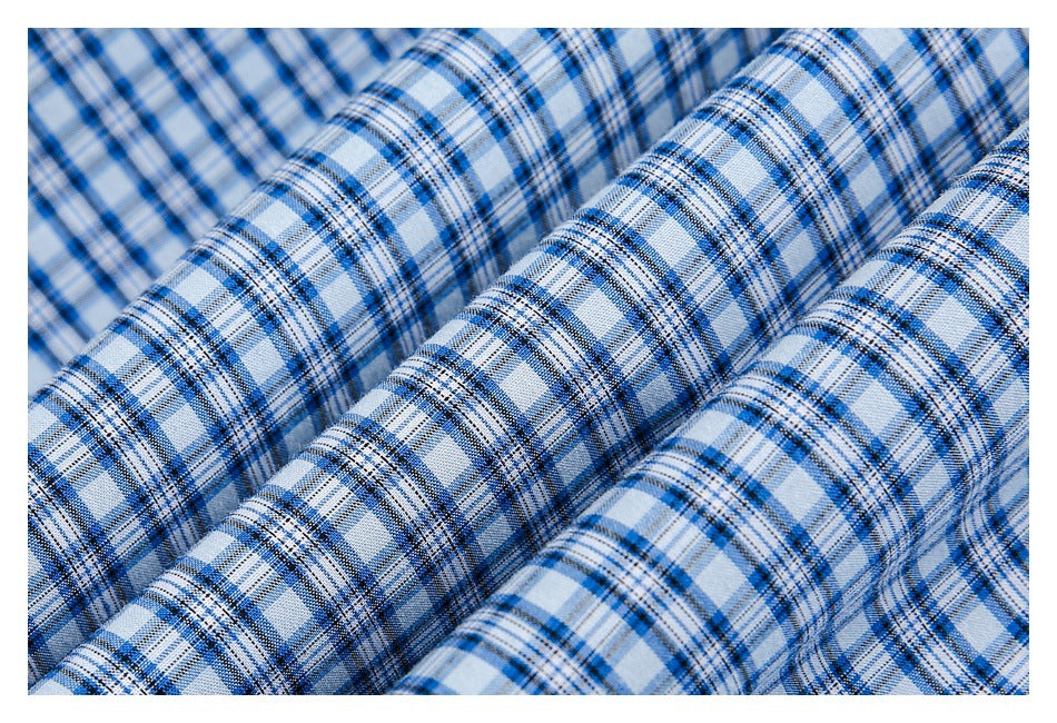 Close-up of blue, white, and black plaid fabric arranged in soft folds.
