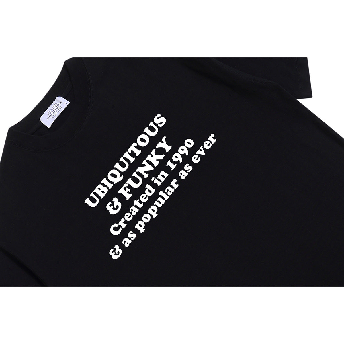 Close-up of a black T-shirt showing its white chest lettering and crew neckline.