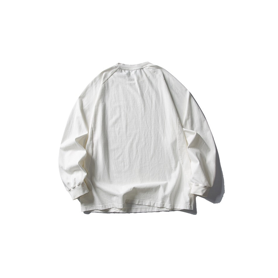 Back view of a white long-sleeve raglan crewneck top with ribbed cuffs and neckline.