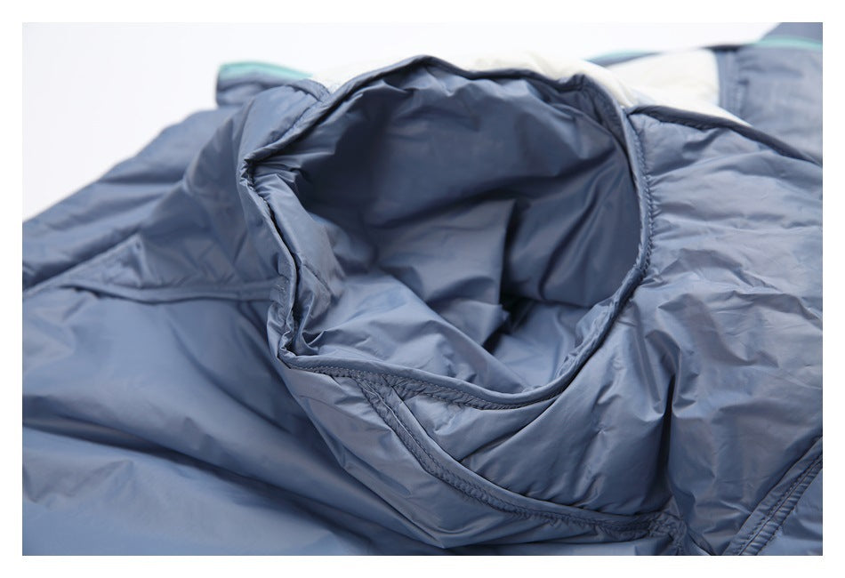 Close-up of an open pocket in blue jacket fabric, showing the pocket interior and stitched edge.