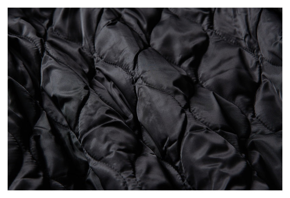 Close-up of the jacket's black quilted lining and stitched seams.