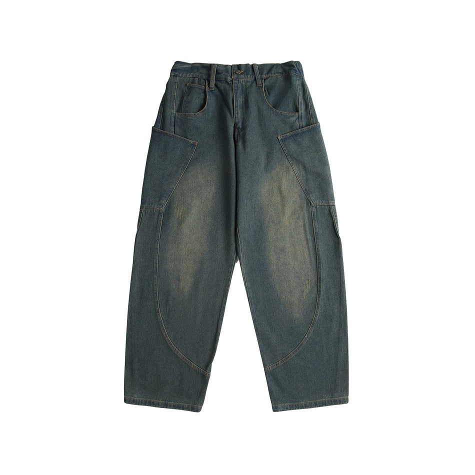 Front of faded blue-green wide-leg denim jeans with curved side panels and patch pockets on a white background