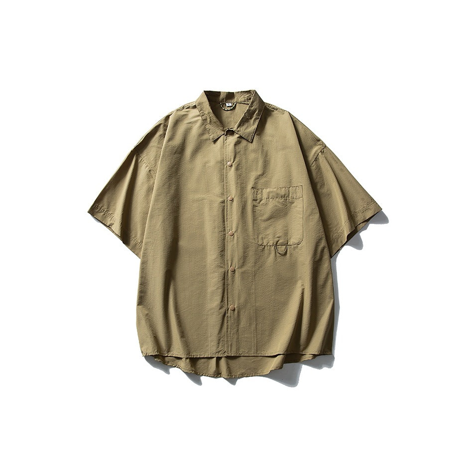 Khaki tan short-sleeve button-front shirt with collar and chest pocket, flat lay on white background