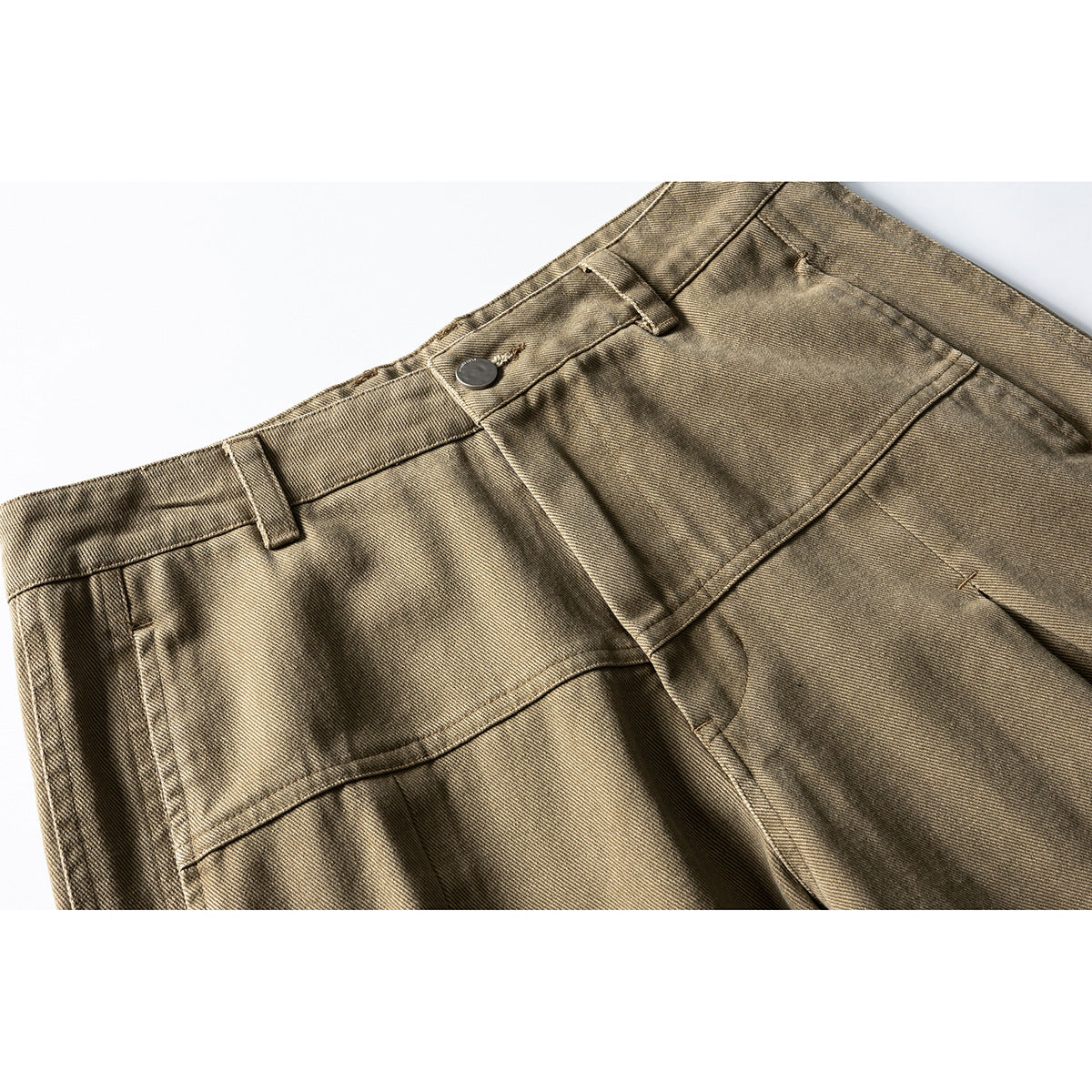 Close-up of taupe wide-leg pants showing the waistband, button, belt loops, and curved front seam.