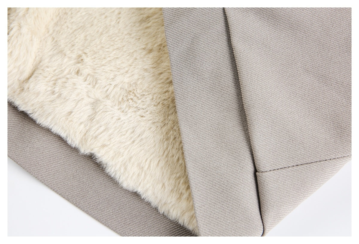Close-up of cream plush lining exposed along the edge of a light taupe garment.