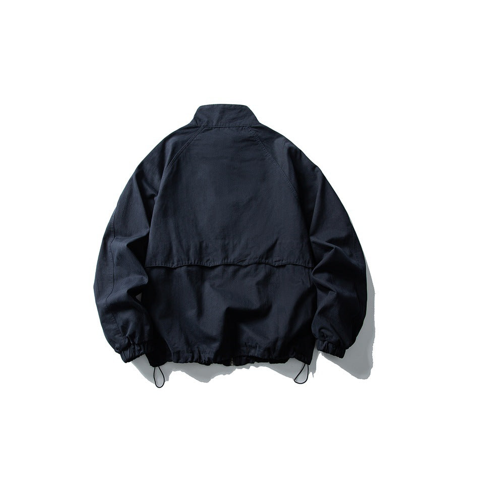 Back view of navy stand-collar jacket showing horizontal yoke seam, elastic cuffs and drawcord hem