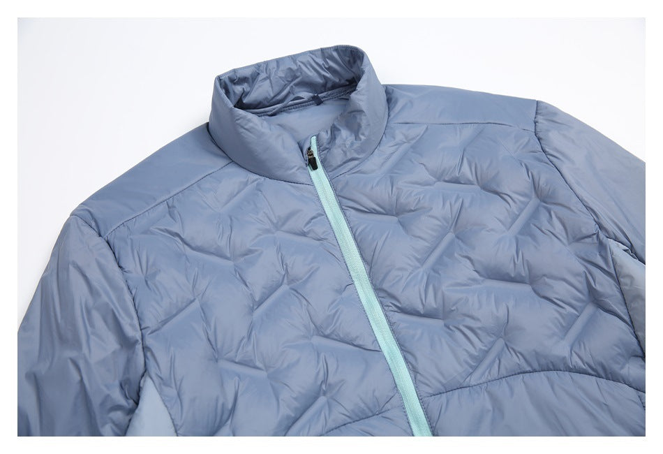 Close-up of a pale blue jacket showing its stand collar, mint zipper, and quilted upper panels.
